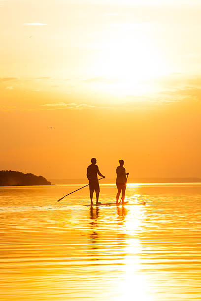 istock Couple Stand Up Paddle Boarding at Sunset 475526940