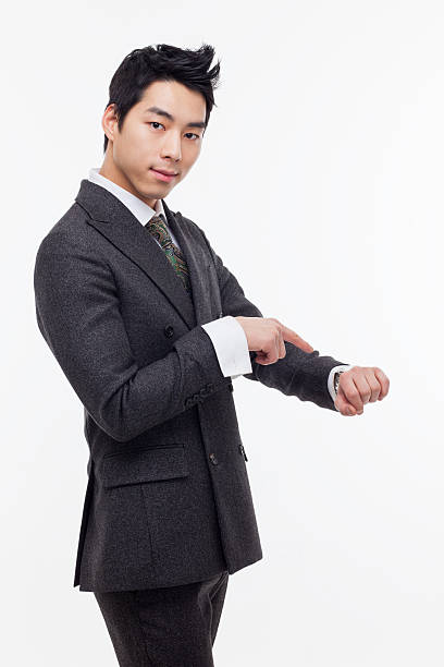 istock Young business man consulting his watch 475529065