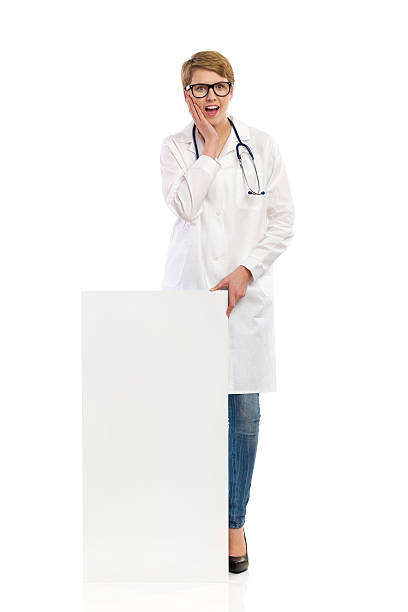 istock Surprised female doctor stands behind bar chart. 475529461