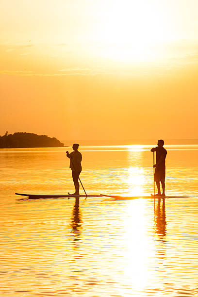 istock Couple Stand Up Paddle Boarding at Sunset 475529840