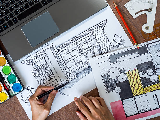 istock Top view of hands working with architecture hand-drawn sketch 475530072