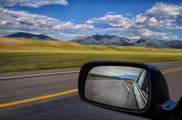 Rear-view mirror Looking through the rearview mirror while driving in the planes montana western usa photos stock pictures, royalty-free photos & images