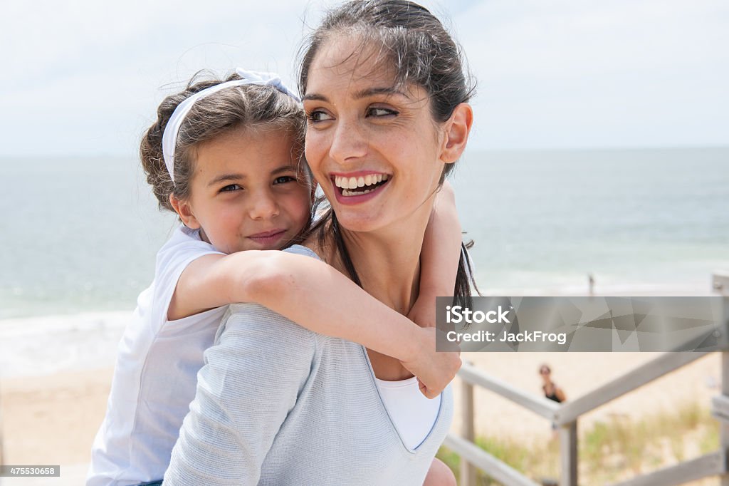 beautiful mom and her daugther at seaside smiling at camera Mother Stock Photo