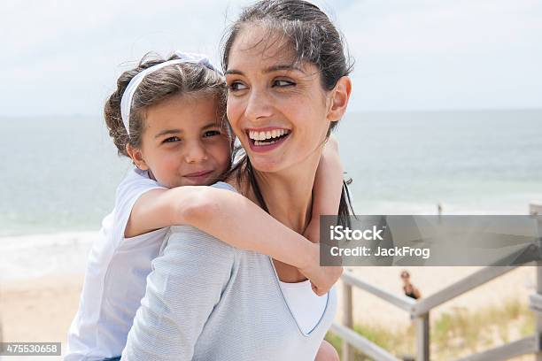 Beautiful Mom And Her Daugther At Seaside Smiling At Camera Stock Photo - Download Image Now