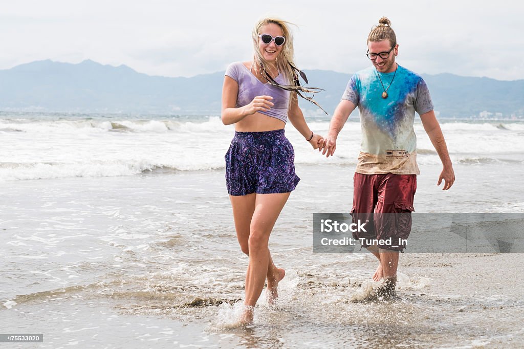 Couple walking at beach. Riviera Nayarit, Pacific Coast, Mexico Couple walking at beach. Overcast sky. Riviera Nayarit, Pacific Coast, Mexico 2015 Stock Photo