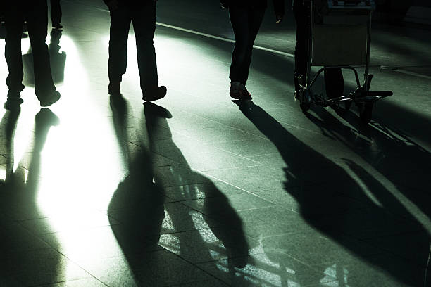 istock walking people at an airport 475534117