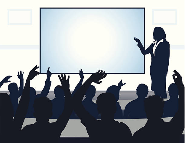 reading Auditorium filled with eager students. The speaker points to a screen serving as copy space. Files included – jpg, ai (version 8 and CS3), svg, and eps (version 8) teacher projector stock illustrations