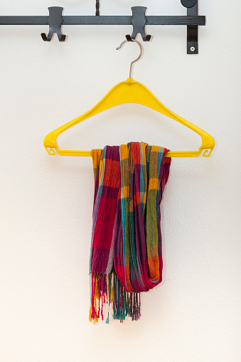Coat rack with scarf on plastic hanger