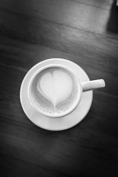 istock cup of latte art coffee on wood table 475536510