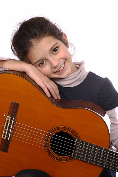 istock Young girl with guitar 475541955
