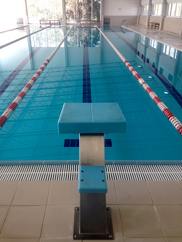Olympic Swimming Pool with stair and starting blocks before competition