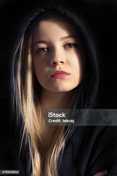 Pensive Young Woman Stock Photo - Download Image Now - Dark, Hood - Clothing, 2015
