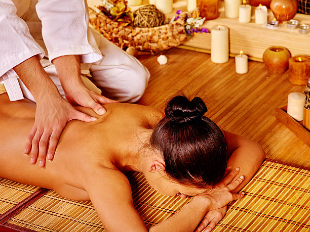 Woman getting bamboo massage stock photo