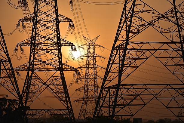 istock High-voltage tower with sunset and sky background 475556118