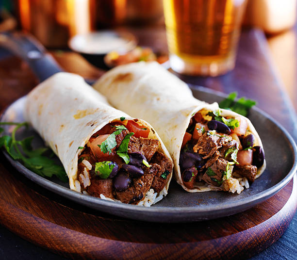 two beef steak burritos two beef burritos with rice, black beans and salsa latin music photos stock pictures, royalty-free photos & images