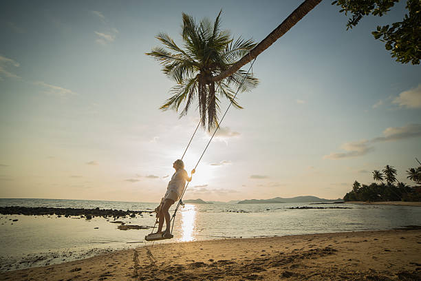 istock Young woman on a swing in a tropical Island. 475557009