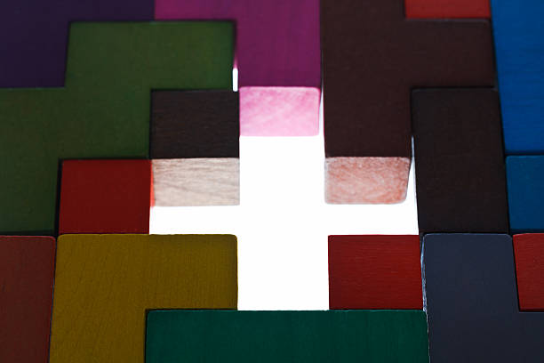 istock illuminated cross shape hole in wooden puzzle 475557347