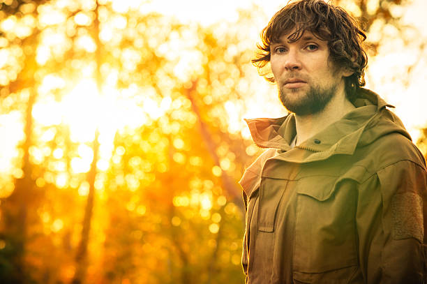 istock Young Man standing alone in forest outdoor 475558978