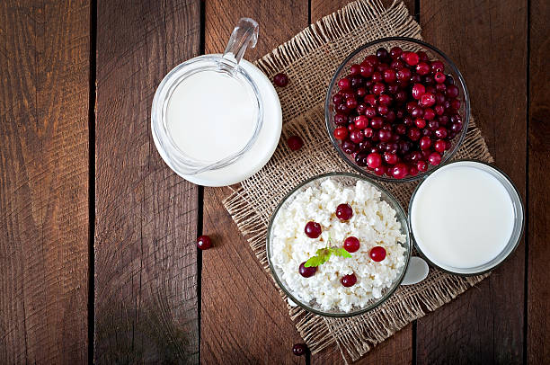 istock Cheese, milk and cranberries on a wooden table 475559318