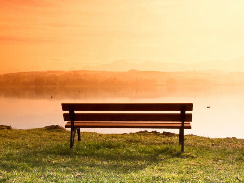 bench at a lake (83) in upper bavaria with mountains in background