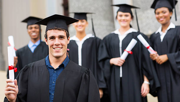 istock male university graduate holding diploma 475565499