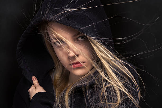 istock scared girl in black 475566958