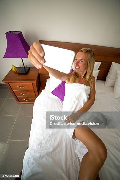 Young Woman Taking A Selfie On Bedbedroom Stock Photo - Download Image Now - Bed - Furniture, Domestic Life, 2015