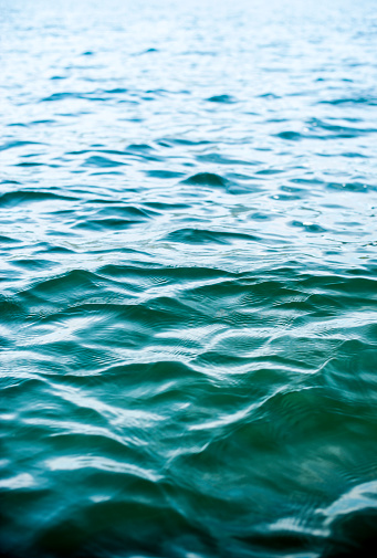 High contrast image of small ripples and waves of a deep green lake with nice depth of field