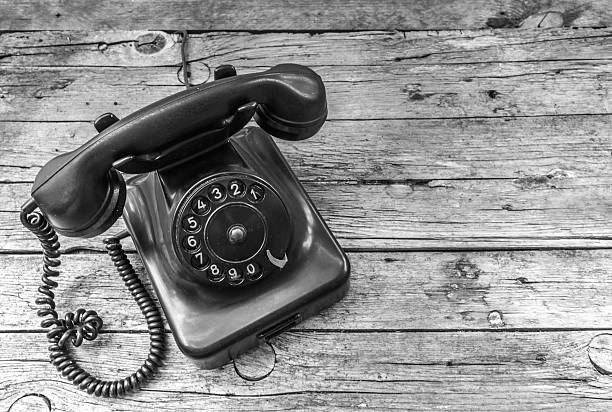 istock Old telephone on wooden background 475570958