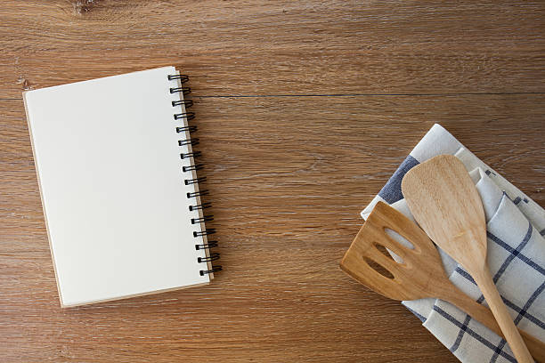 istock wooden spoon and notebook on old wooden table 475571468