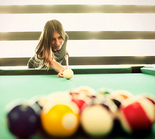 istock Young woman playing pool 475571760