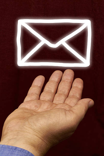 newsletter An white envelope floating above a hand. levitation stock pictures, royalty-free photos & images