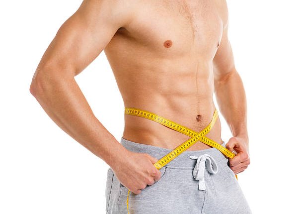 istock Athletic man with measuring tape on the white 475582770