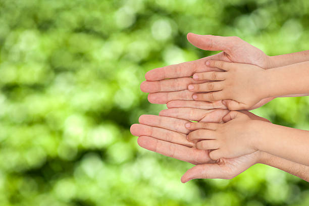 istock father and son holding hands on natural background 475585872