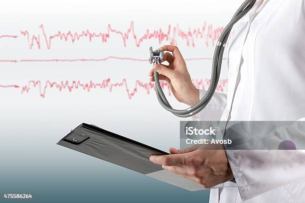Female Doctors Hand Holding Stethoscope And Clipboard On Medical Background Stock Photo - Download Image Now
