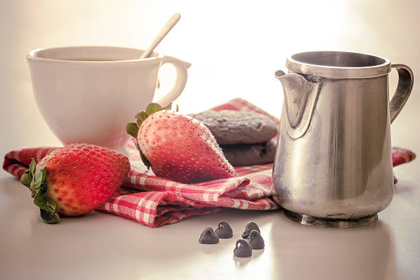 Cup of tea with strawberries stock photo