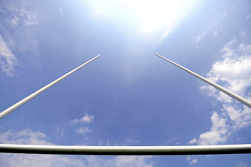 Rugby goal posts with stadium spotlights and blue sky on the background