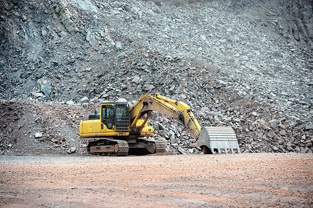 istock Earth mover in front of rocks 475595296