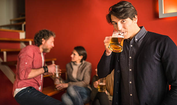 istock group of friends toasting with drinks 475596684