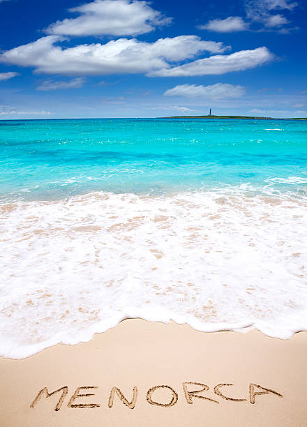 istock Menorca word written on sand of mediterranean beach 475599996