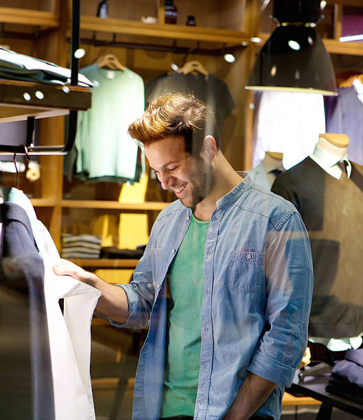 istock Happy man shopping for clothes at shop 475602748
