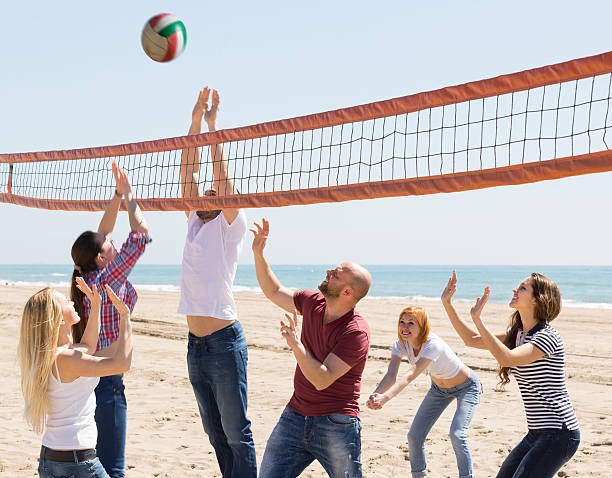 istock Friends playing volleyball at beach 475605032