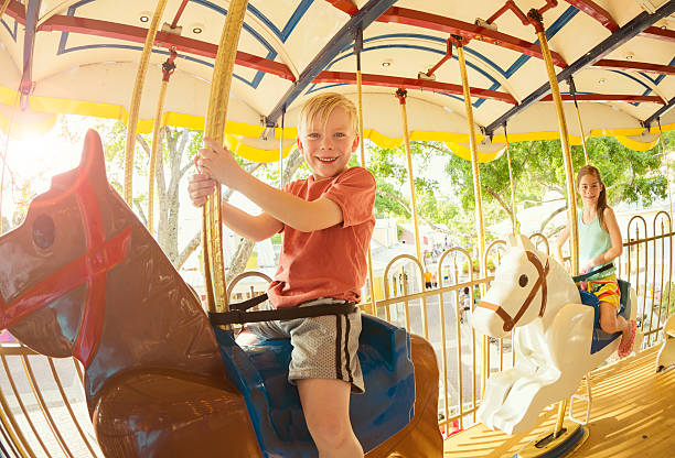 istock Kids having fun on a Carnival Carousel 475605340