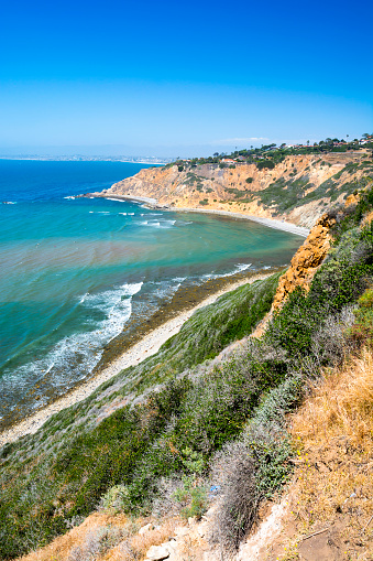 A beautiful ocean image along the cliffs in Palos Verdes California shows a remote cove and bright, sunny day.