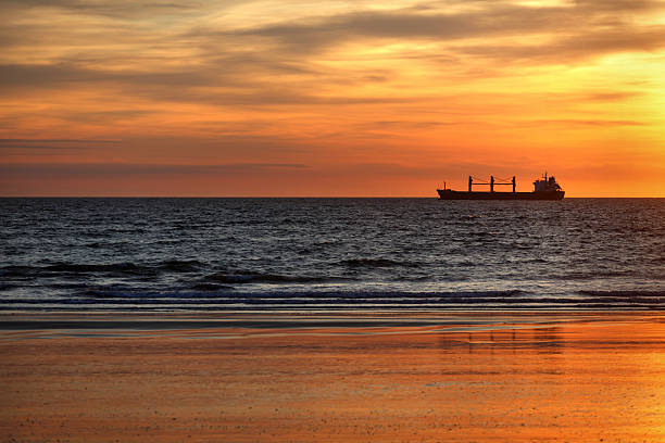 istock Cargo ships in the ocean at sunset 475606310