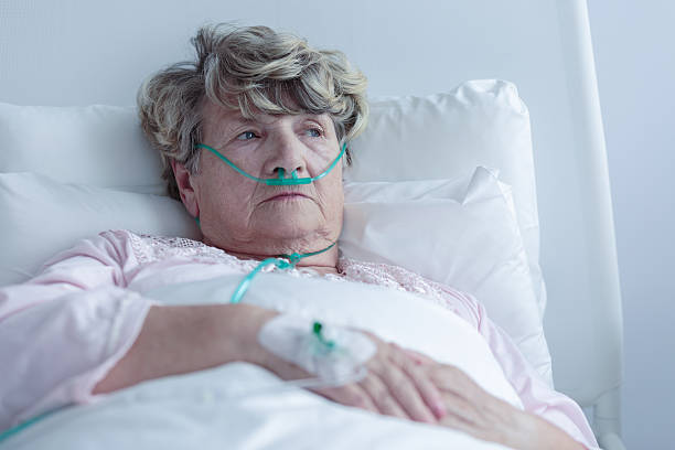 Female senior with nasal cannula Female senior with nasal cannula staying in hospital tracheotomy tubing stock pictures, royalty-free photos & images