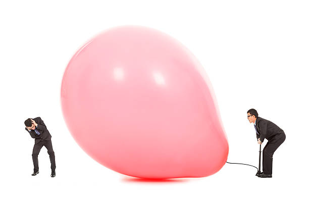 Businessmen scared balloon is inflated to burst Businessmen scared balloon is inflated to burst over white background air pump stock pictures, royalty-free photos & images