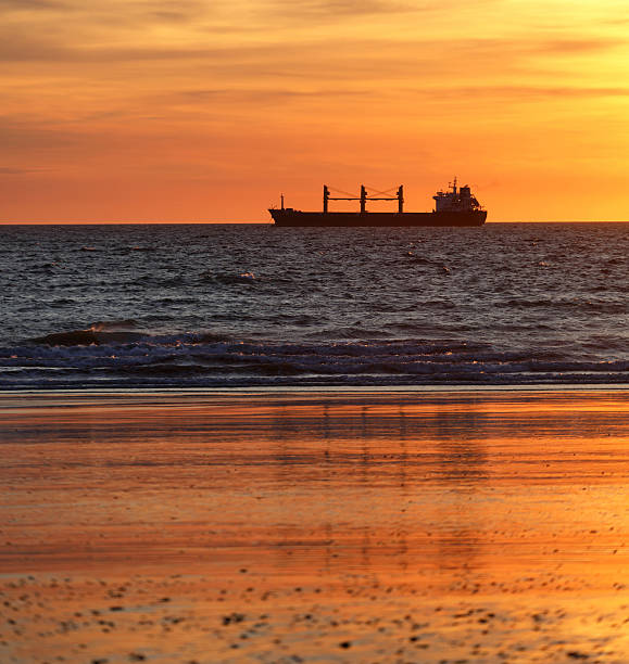 istock Cargo ships in the ocean at sunset 475607274