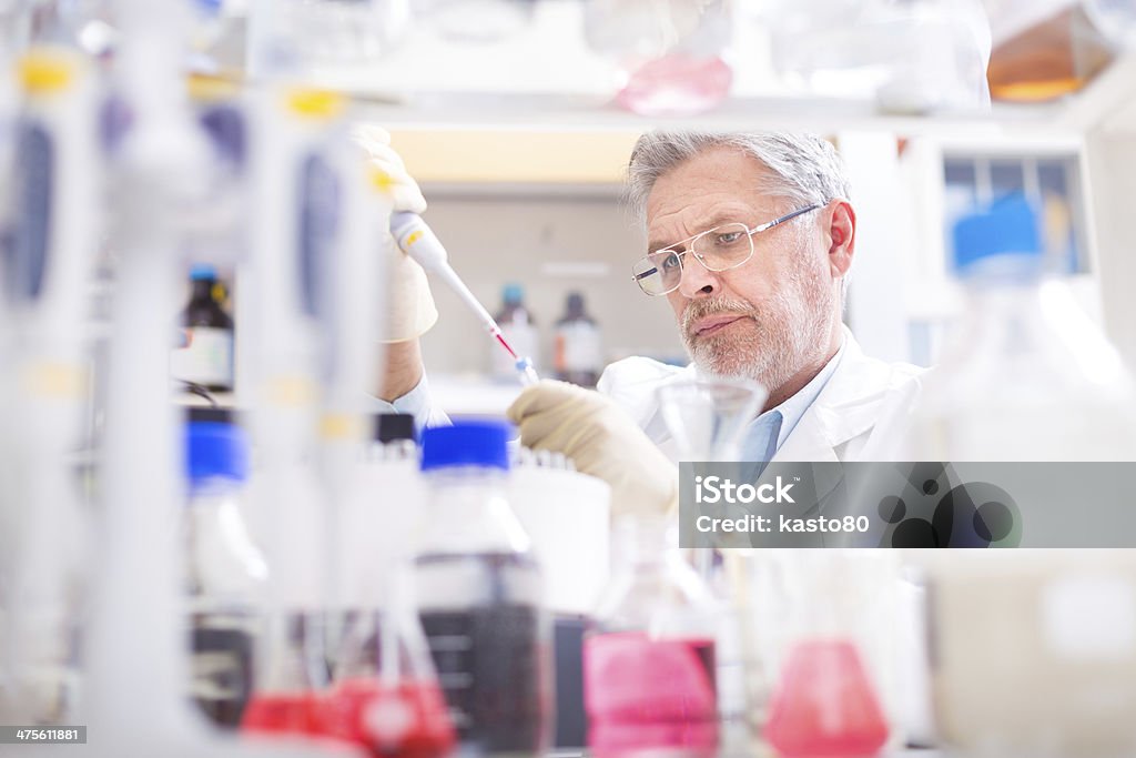 Life scientist researching in the laboratory. Life scientist researching in laboratory. Life sciences comprise fields of science that involve the scientific study of living organisms: microorganism, plant, animal and human cells, genes, DNA... Cancer - Illness Stock Photo