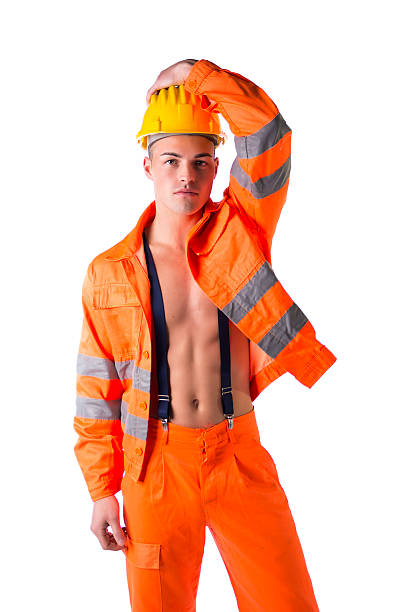 istock Young construction worker with orange suit open on naked torso 475612585